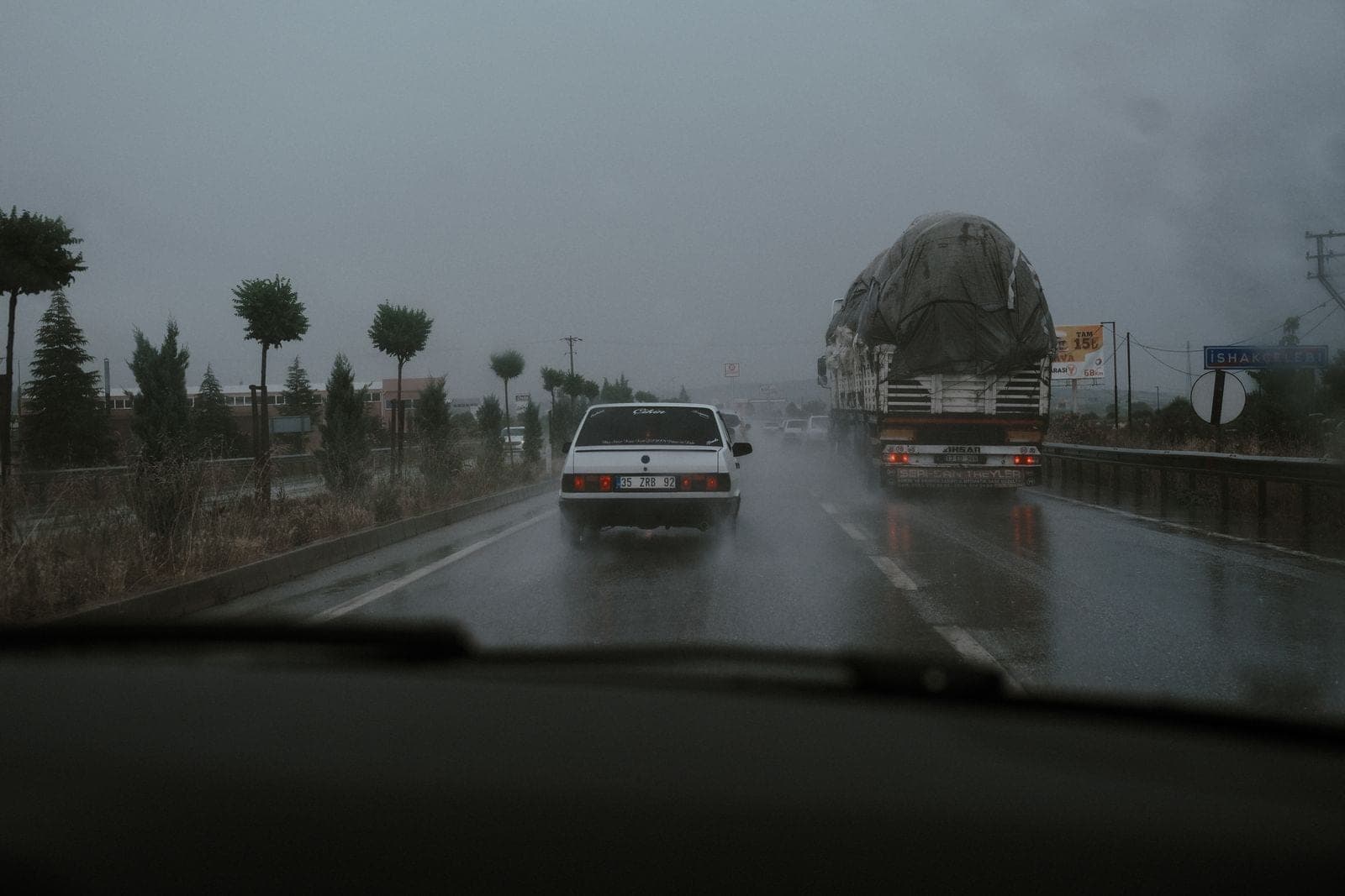 Cars driving on a wet highway in heavy rain